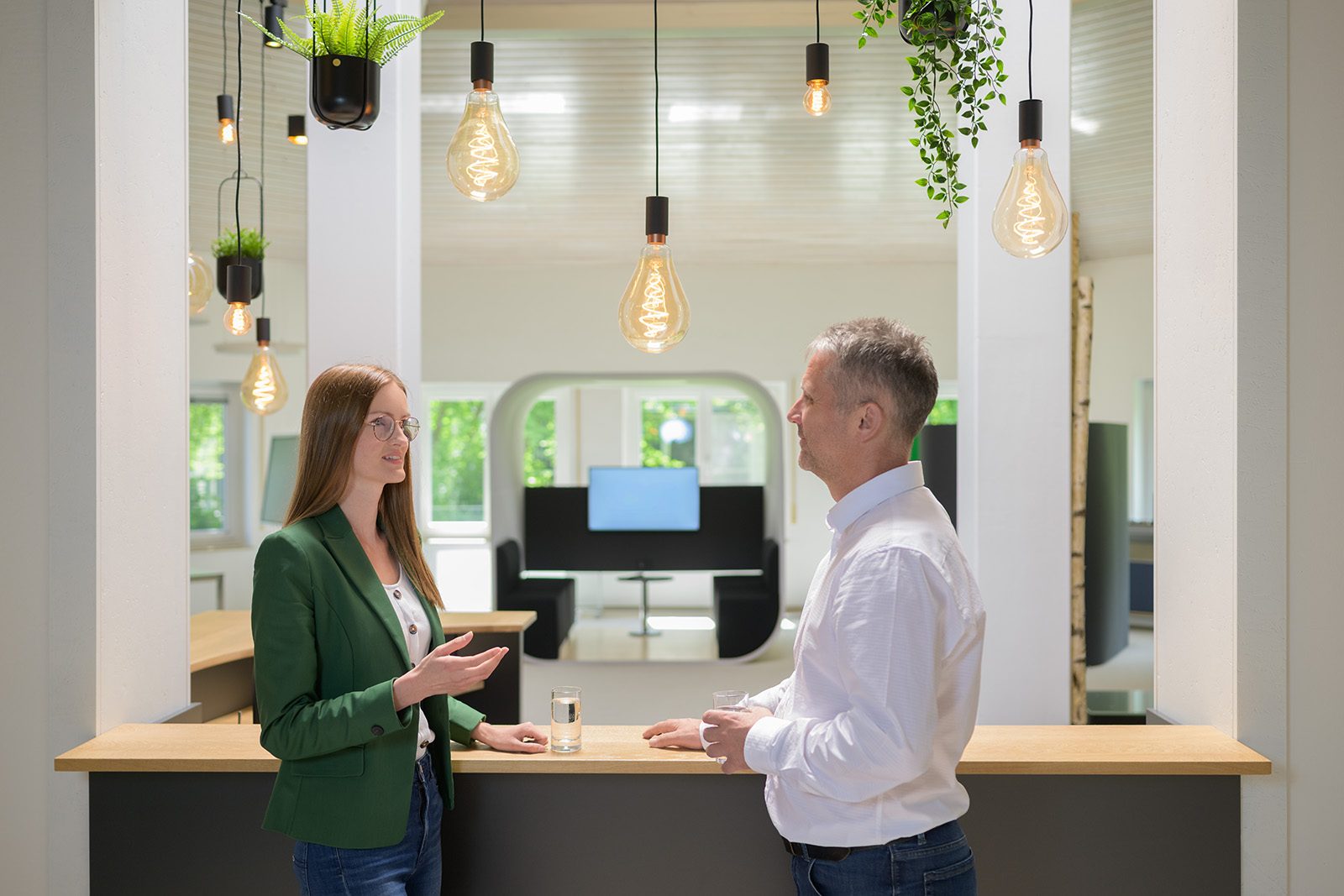 Two employees talking in a bright modern office in Germany